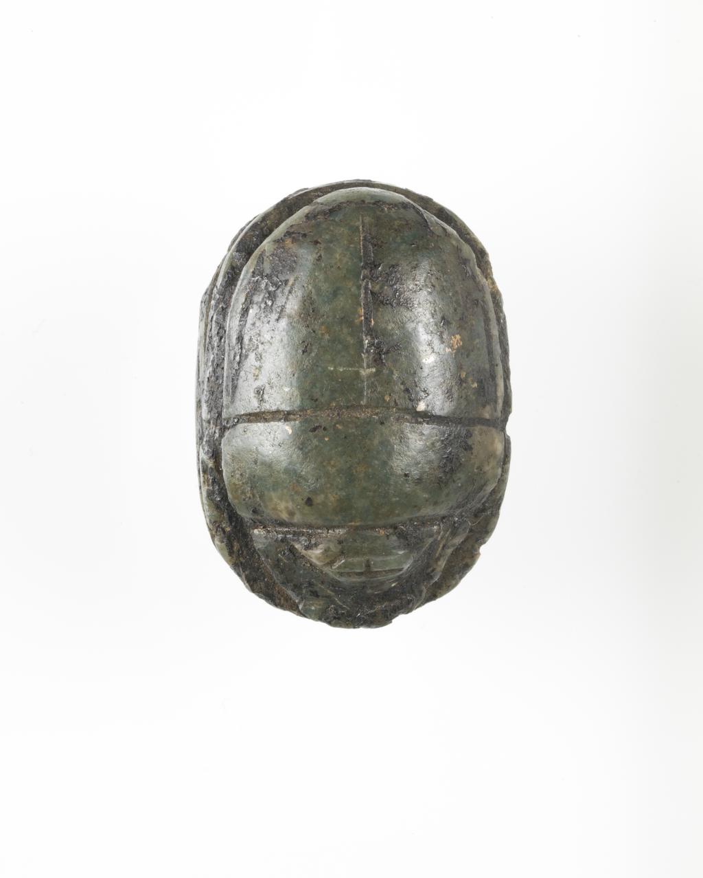 An image of Scarab. Heart scarab, uninscribed found on Nekhtefmut's chest. Production Place: Egypt. Find Spot: Ramesseum, Thebes, Egypt. Depth 1.2 cm, length 2.6 cm, width 1.8 cm, circa 923 B.C. Twenty-second Dynasty. Third Intermediate period, reign of Osorkon I.