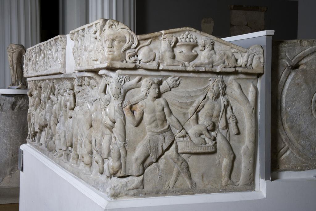 An image of Funerary Equipment. Pashley Sarcophagus, with relief showing triumphal return of Dionysos. Carved Luna Marble, height 0.697 m, length 2.22 m, weight 1.4 tonne, width 0.67 m. 101-200 AD, Middle Roman Period. Find Spot: Arvi Crete Greek Islands.
