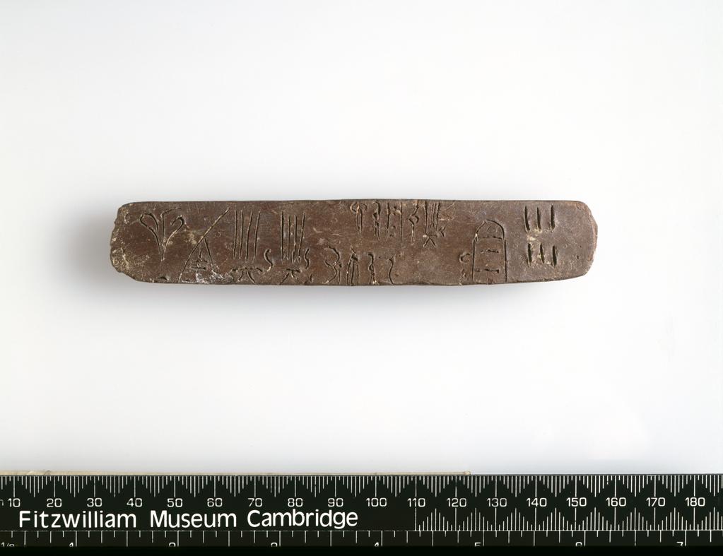 An image of Name: writing-tablet Description: tablet, linear B Dimensions: height 0.014 m, length 0.121 m Production Place: Crete Greek IslandsPeriod: Minoan, Bronze Age