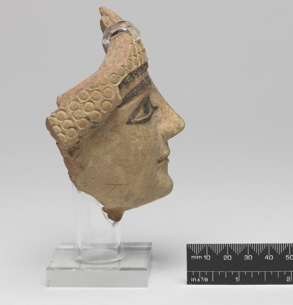 An image of Figure/Head. Male head, wearing cap. Production Place: Cyprus. Find Spot: Salamis, Temple of Apollo, Cyprus. Clay, moulded, height 101 m, width 0.077 m, 600-501 B.C. Archaic Period.