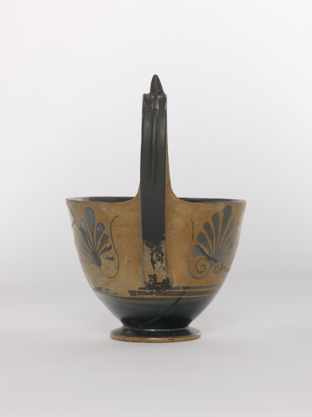 An image of Vessel. Kyathos, battle scene. Production Place: Athens, Attica, Greece. Clay, black-figured, depth 0.109 m, width 0.15 m, height 0.055 m, height 0.152 m, 510 to 500 B.C. Archaic Period.