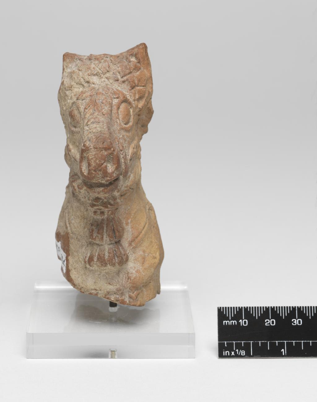An image of Figure/Figurine fragment. Horse's head. Production Place: Cyprus. Find Spot: Salamis, Cyprus. Clay, moulded, height 0.099 m, width 0.066 m, 600-501 B.C. Archaic Period.