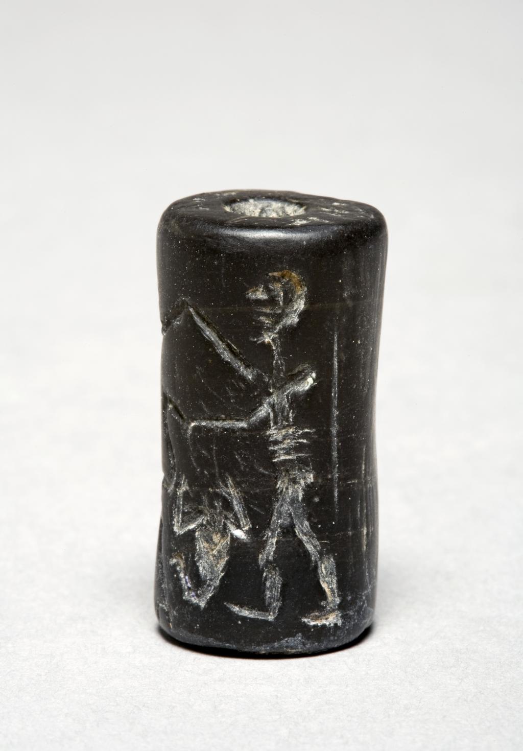 An image of Seal. Black inscribed cylinder seal. Basalt, height 0.030 m, width 0.016 m, circa 2230-2000 B.C. Notes: inscription faded, fake. Post-Akkadian/Ur III. Cf. Collon WAS II figs. 247, 249.