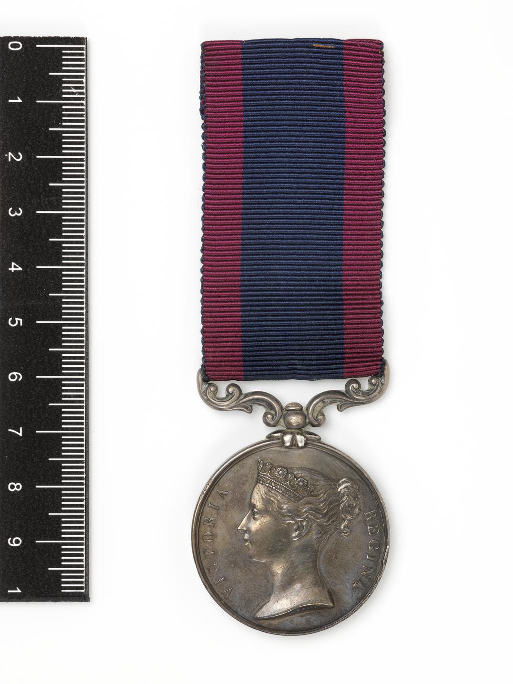 An image of Medal. Sutlej Campaign Medal (Ferozeshuhur). Victoria (1837-1901), ruler; Queen of Great Britain 1837-1901. Obverse; VICTORIA REGINA; Bust of Victoria facing left. Reverse; Victory standing facing left holding wreath with war spoils at feet; exergue bears inscription "FEROZESHUHUR". Wyon, William, artist (British). London mint. Silver, struck, weight 36.34 g, diameter 36.3 mm, 1846. Notes: This example was awarded to Private Francis Greenway of the 29th Regiment, who fought in an inconclusive but mutually costly attack at Ferozeshah soon after the outbreak of war, on 21 December 1845.