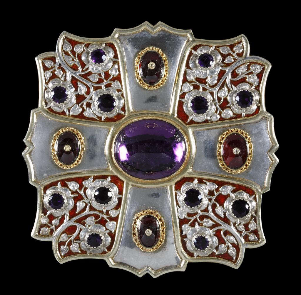 An image of Morse. Krall, Carl Christof (1845-1919). Silver, silver gilt and reddish brown translucent enamel set with amethysts and garnets. Maker’s mark of Carl Christof Krall. In red leather covered box lined with red velvet and white silk painted in gold ‘BARKENTIN & KRALL/ Goldsmiths/ 291/ REGENT ST. W.’ (A). 1898. Lent to the museum by The Keatley Trust.