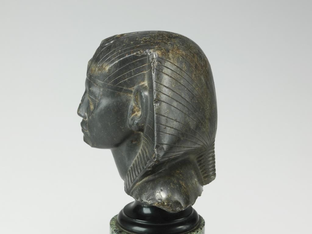 An image of Statue/Figure. Head of King Amenemhet III, wearing nemes head-dress. Find Spot: Aswan, Egypt. Shelly limestone, length 12 cm, width 14.3 cm, circa 1831-circa 1786 B.C. Twelfth Dynasty, Middle Kingdom. Reign of Amenemhat III. Production Notes: Only the shoulders and head are preserved; the base is modern. The statue was found in a private tomb. The facial features are a softer version of the so-called 'realistic portraits' of Senusret III. In this way the ruler was able to promote a visual link to his predecessor.