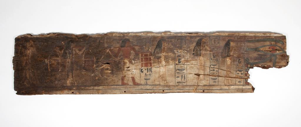 An image of Funerary Equipment. Coffin fragments, decorated. This coffin shows a procession of mourners, who consisted of friends, servants and family of the deceased. Unlike the Middle Kingdom eye coffins, where both eyes are shown on a single panel, this example only has one eye on each of the side panels. Production Place: Egypt, Find Spot: Arabah, el- Egypt. Wood, painted, height 39.3 cm, length 111.6 cm, 1580-1550 B.C. Previously attributed to Dynasty 13. Seventeenth Dynasty. Middle Kingdom.