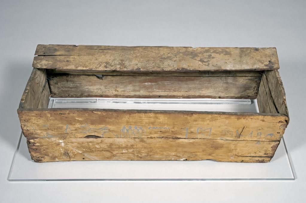 An image of Funerary equipment. Coffin. This dog was given his own tomb and is named in the coffin text five times. His names was 'Heb'. Production Place: Egypt. Find Spot: Beni Hasan. Wood, height 21 cm, length 70 cm, width 27 cm. Eleventh Dynasty; Twelfth Dynasty; Middle Kingdom, 2119-1794 B.C.