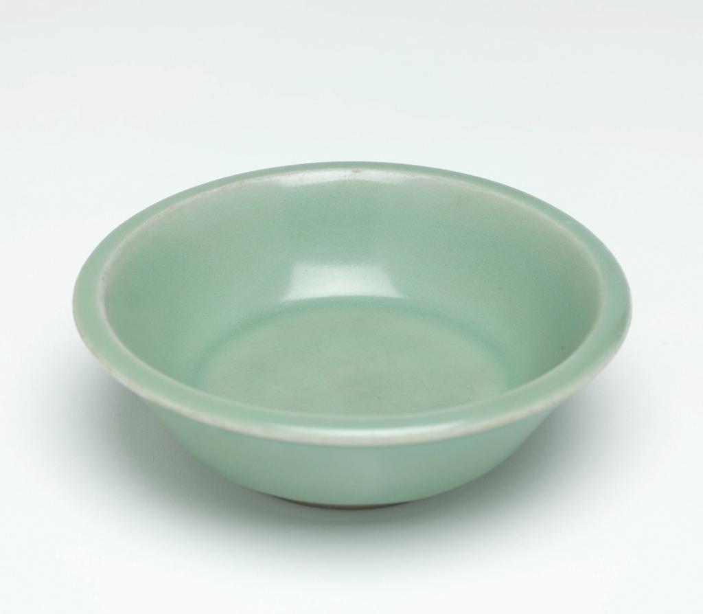 An image of Saucer. Longquan Kilns, Zhejiang, China. Straight-sided deep saucer, decorated with a good heavy Kinuta bluish-celadon glaze. Diameter 10.2 cm. Song Dynasty (960-1279). Acquisition Credit: Lent to the museum by Helen H. L. Whittow (nee Malcolm). Acquisition Credit: Lent to the museum by Helen H. L. Whittow (nee Malcolm).