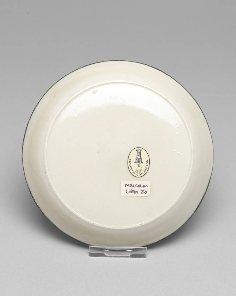 An image of Saucer. Ding Yao ware. The saucer is circular with shallow sloping sides. The flat centre is incised with a lotus flower and foliage. With an oval label printed in black, with a tower and 'Malcolm Collection', and inscribed in blue black ink with 'D./49'. White stoneware, with an incised decoration under the ivory white glaze, and a rim mounted in what may be copper. Height 2.5 cm, diameter 13 cm, 960- 1127. Northern Song (960-1127). Chinese. Acquisition Credit: Lent to the museum by Helen H. L. Whittow (nee Malcolm).