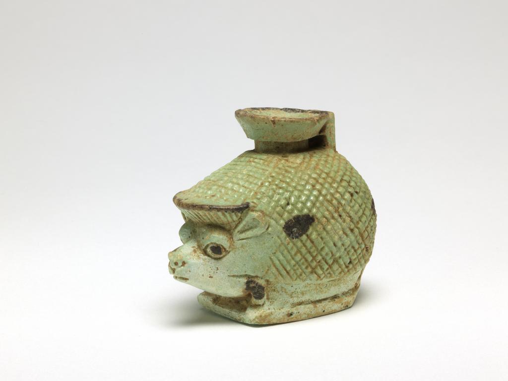 An image of Aryballos cosmetic vessel in the form of a hedgehog. Dimensions height 0.054 m, length 0.066 m, width 0.041 m.