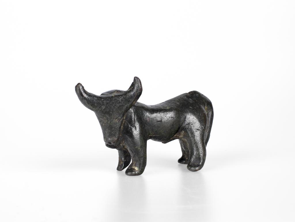 An image of Figurine of a bull, Greek. Copper alloy, height 0.05 m, length 0.087 m, 600-501 B.C. Field Collection: Cesme, Ionia, Turkey. East Greece.
