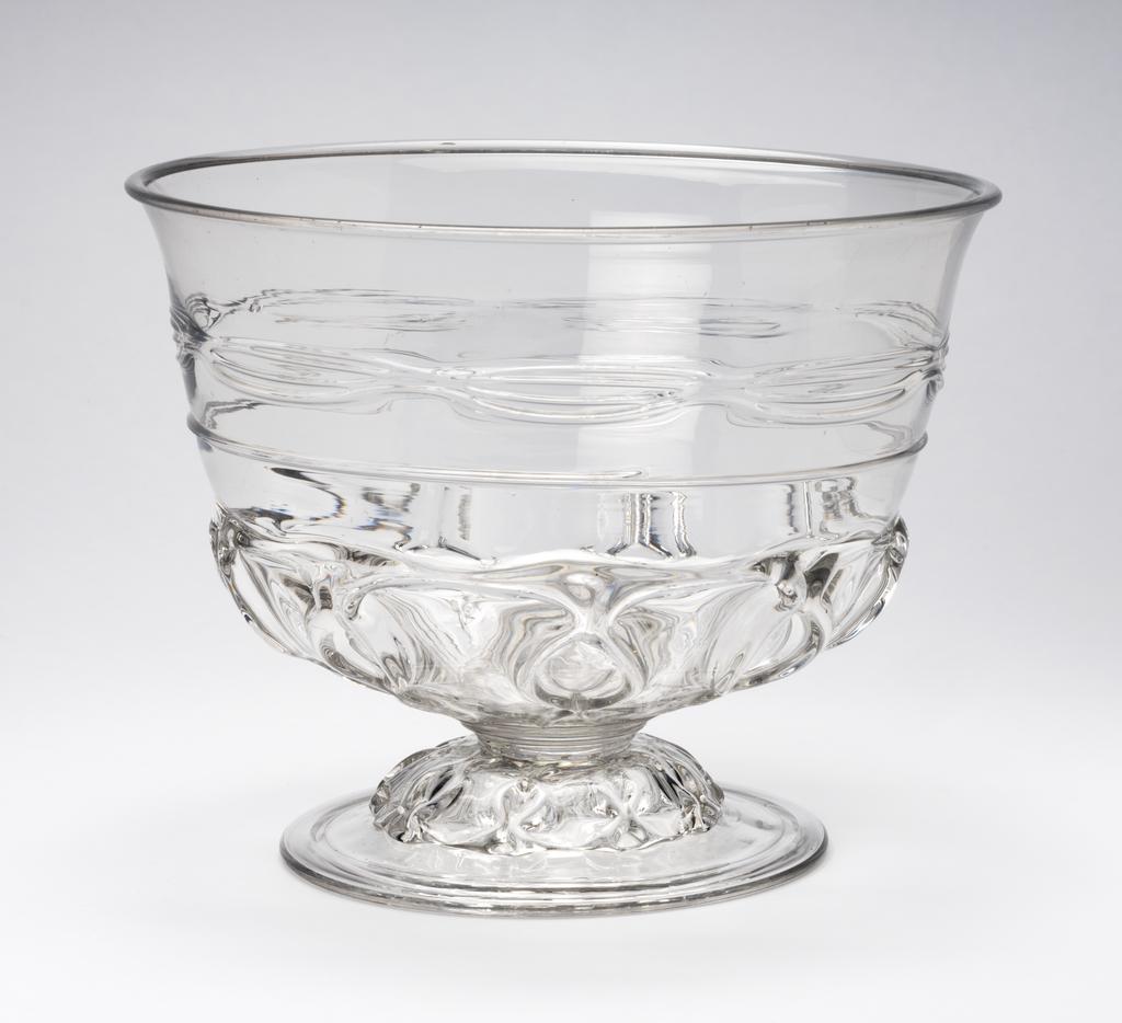 An image of Punch Bowl. Unidentified English glasshouse. Blown lead-glass, with diamond-pincered moulded ribbing on the lower part and a horizontal band of trailed threading above. 1695-1700. Baroque. Sir Ivor and Lady Batchelor Bequest through The Art Fund.