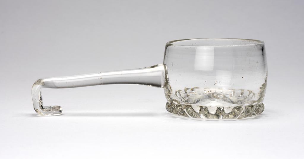 An image of Ladle. Unidentified glasshouse, England. Production Note: The hook at the end of the handle allowed the ladle to be hooked over the side of the rim of a punch bowl. Lead glass, height, whole, 5 cm, length, whole, 16.5 cm, circa 1690-1700. Baroque. Sir Ivor and Lady Batchelor Bequest through The Art Fund.