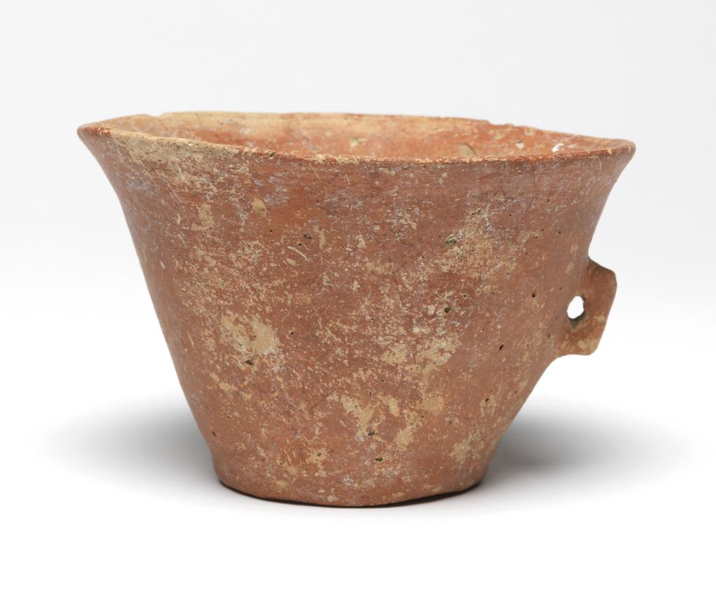 An image of Vessel. Mug.  Production Place: Cyprus. Find Spot: Vounous Cyprus; Tomb 121. Clay, red-polished ware, height 0.077 m, width 0.121 m, 2200 to 2101 B.C. Early Cypriot II. Bronze Age.