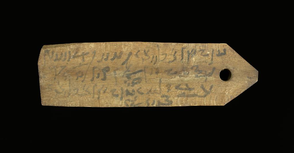 An image of Written document. Mummy label, Demotic. Production Place: Egypt. Wood, length 0.135 m, width 0.04 m. Roman period.
