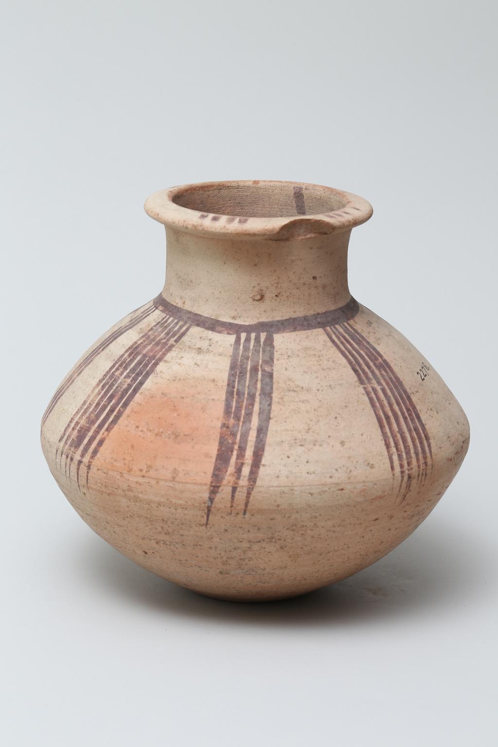 An image of Vessel. Jar, carinated, with line decoration in brown. Production Place/Find Spot: Egypt. Height 0.195 m. Eighteenth Dynasty. New Kingdom.