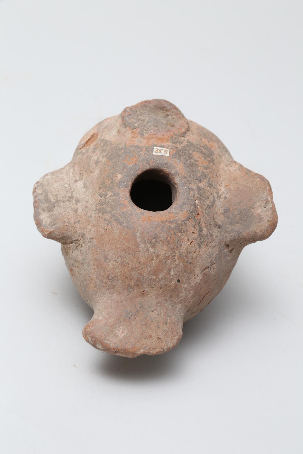 An image of Vessel. Jar, in the form of a bird ?, head missing. Find Spot: Naukratis?, Egypt. Production Place: Egypt. Height 0.105 m.