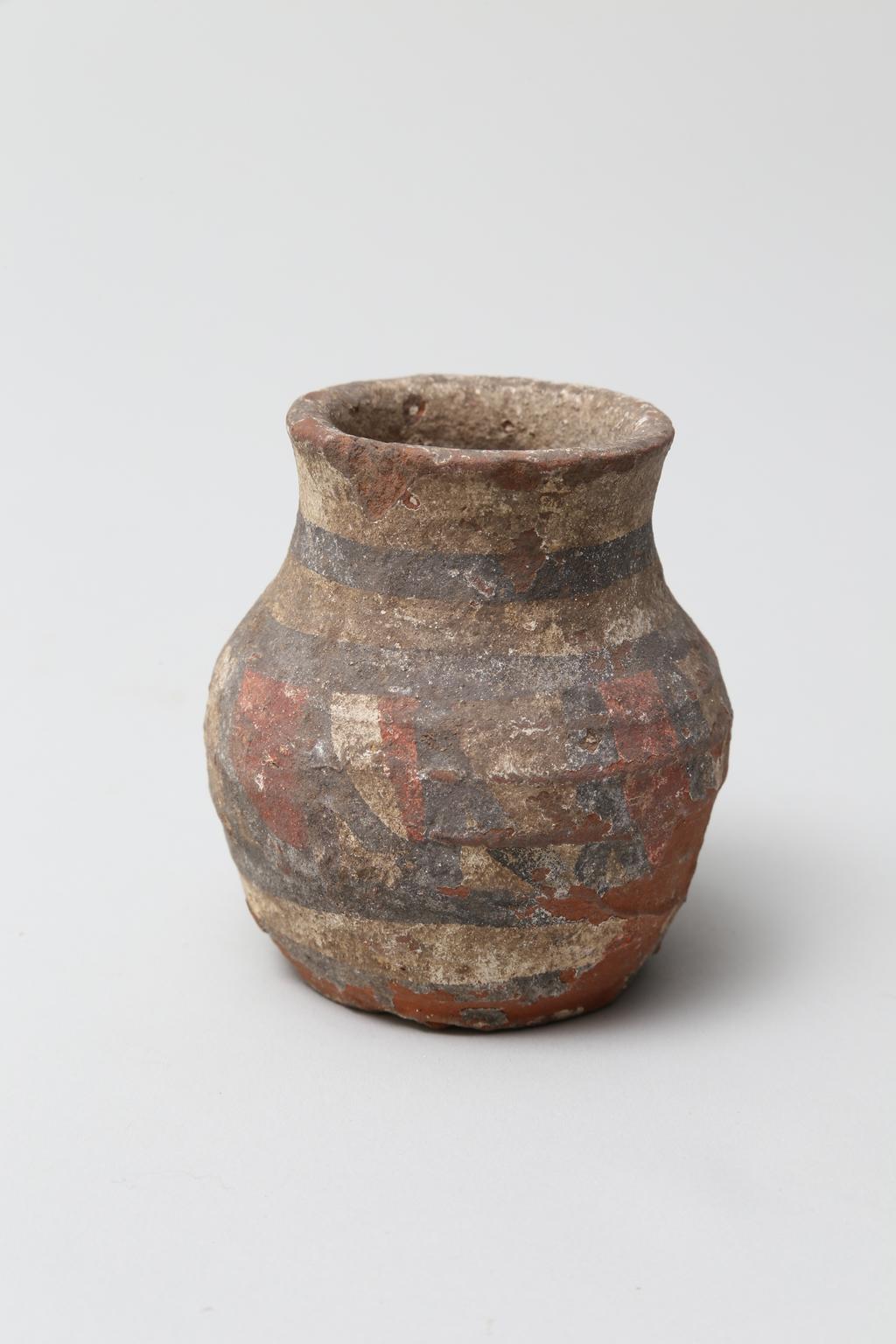 An image of Vessel. Jar, with decoration in black and red paint. Find Spot: Abydos?, Egypt. Production Place: Egypt. Height 0.065 m.
