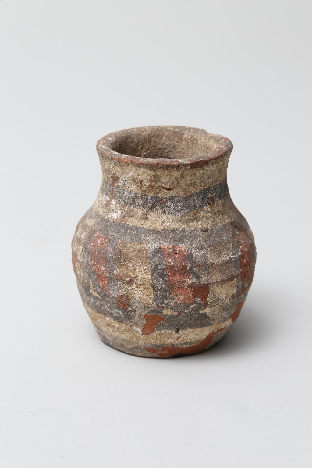 An image of Vessel. Jar, with decoration in black and red paint. Find Spot: Abydos?, Egypt. Production Place: Egypt. Height 0.065 m.