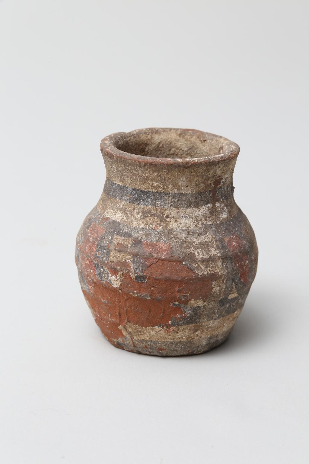 An image of Vessel. Jar, with decoration in black and red paint. Find Spot: Abydos?, Egypt. Production Place: Egypt. Height 0.065 m.