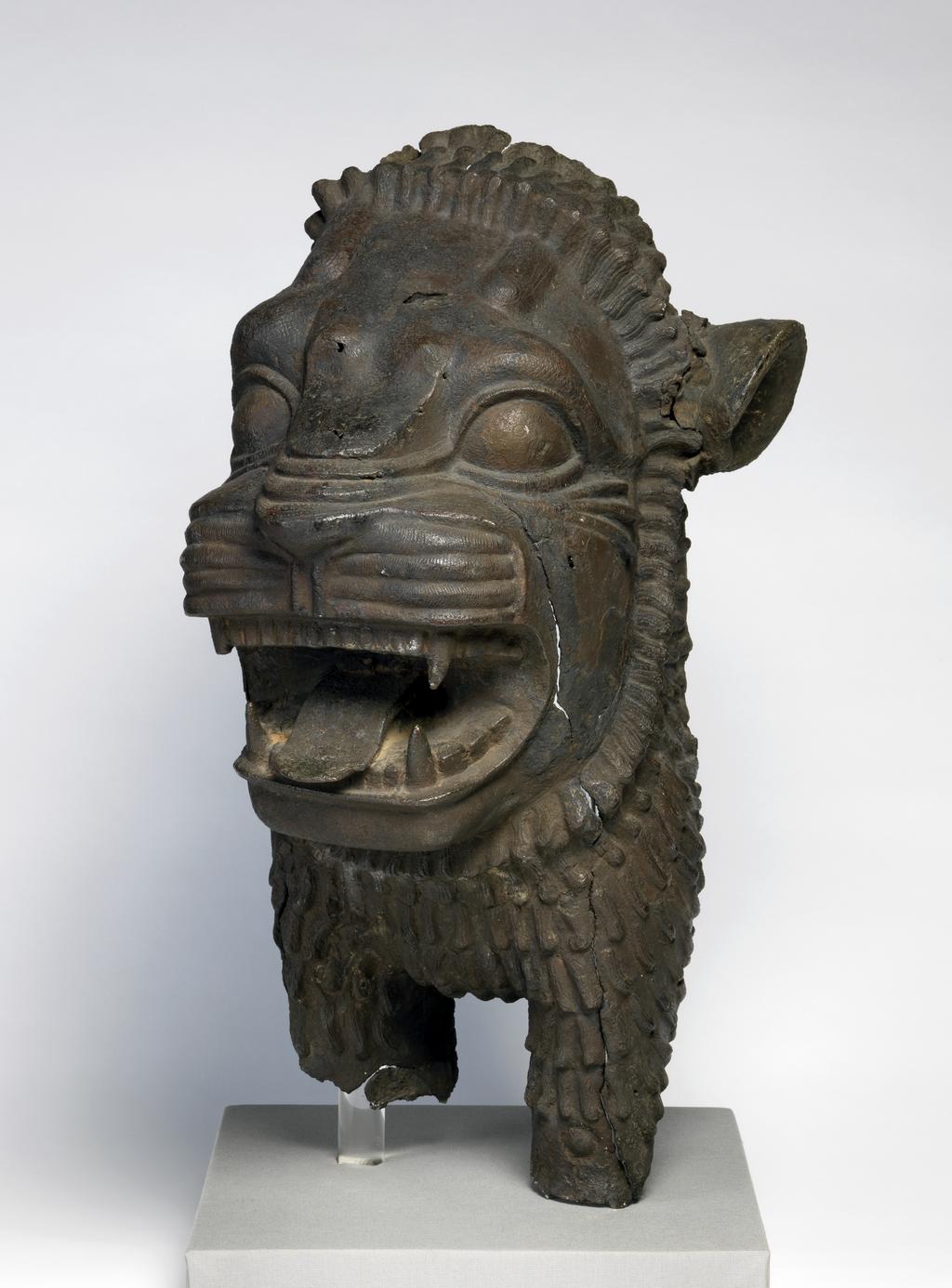 An image of Architectural element/door lintel. Forepart of a hollow cast lion, probably from a door lintel. Find Spot: Shibam? Hadramat, South Arabia. Copper alloy, length 0.556 m, width 0.285 m, circa 800-601 BC.