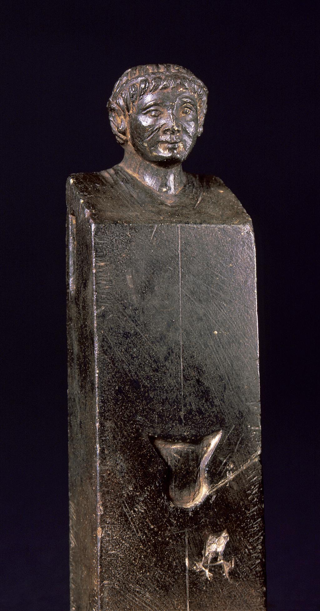 An image of HermSteatite statuette in the form of a HermA herm on a modern base and with the phallus and arm tenons missing. The portrait is that of Ptolemy XV (the son of Cleopatra VII and Julius Caesar), identified as such by the twisted diadem and facial features: forward combed fringe, down-turned mouth.