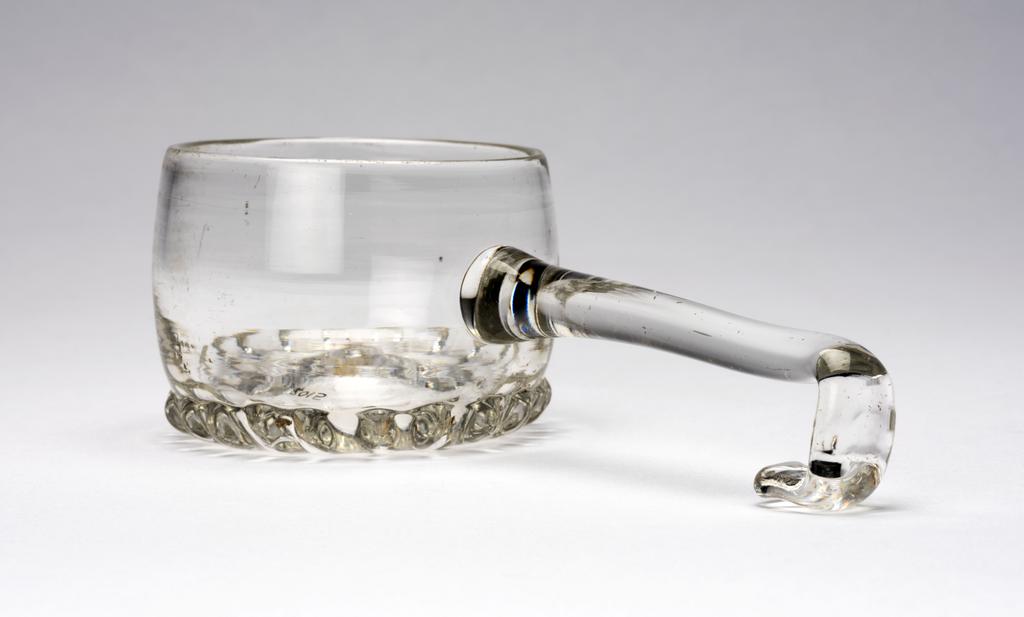 An image of Ladle. Unidentified glasshouse, England. Production Note: The hook at the end of the handle allowed the ladle to be hooked over the side of the rim of a punch bowl. Lead glass, height, whole, 5 cm, length, whole, 16.5 cm, circa 1690-1700. Baroque. Sir Ivor and Lady Batchelor Bequest through The Art Fund.