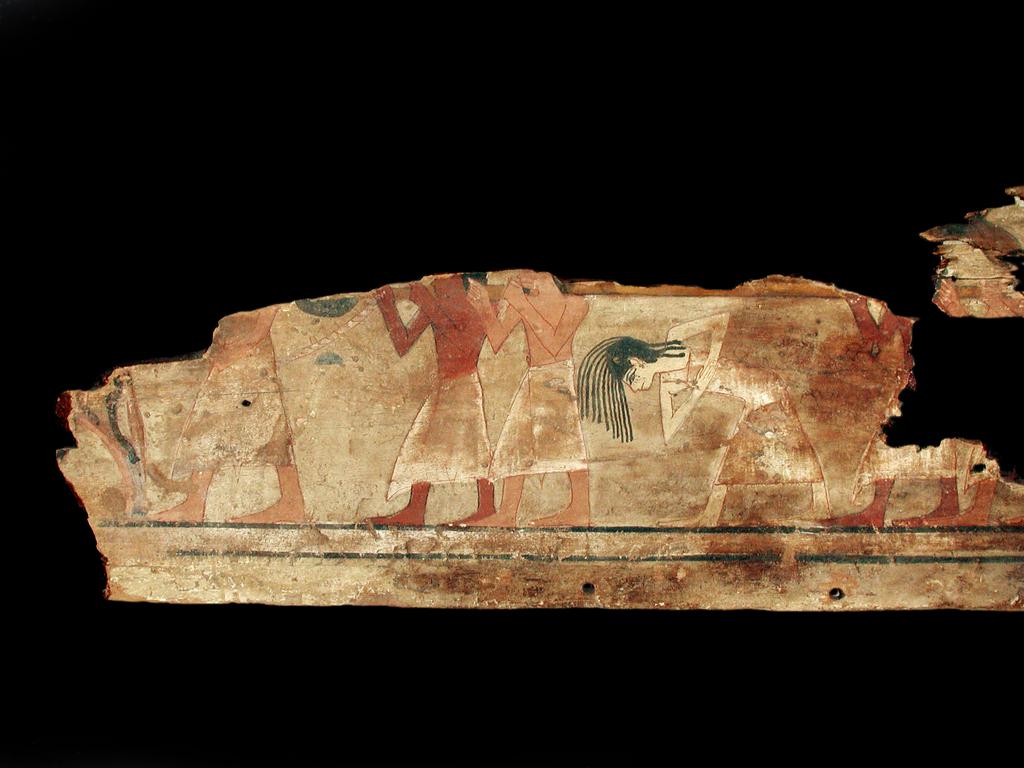 An image of Funerary Equipment. Coffin fragments, decorated. This coffin shows a procession of mourners, who consisted of friends, servants and family of the deceased. Unlike the Middle Kingdom eye coffins, where both eyes are shown on a single panel, this example only has one eye on each of the side panels. Production Place: Egypt, Find Spot: Arabah, el- Egypt. Wood, painted, height 39.3 cm, length 111.6 cm, 1580-1550 B.C. Previously attributed to Dynasty 13. Seventeenth Dynasty. Middle Kingdom.