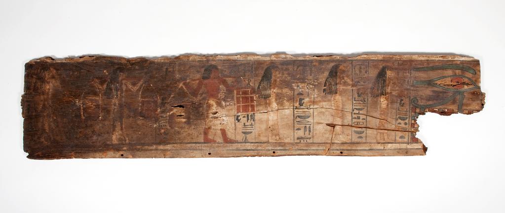 An image of Funerary Equipment. Coffin fragments, decorated. This coffin shows a procession of mourners, who consisted of friends, servants and family of the deceased. Unlike the Middle Kingdom eye coffins, where both eyes are shown on a single panel, this example only has one eye on each of the side panels. Production Place: Egypt, Find Spot: Arabah, el- Egypt. Wood, painted, height 39.3 cm, length 111.6 cm, 1580-1550 B.C. Previously attributed to Dynasty 13. Seventeenth Dynasty. Middle Kingdom.