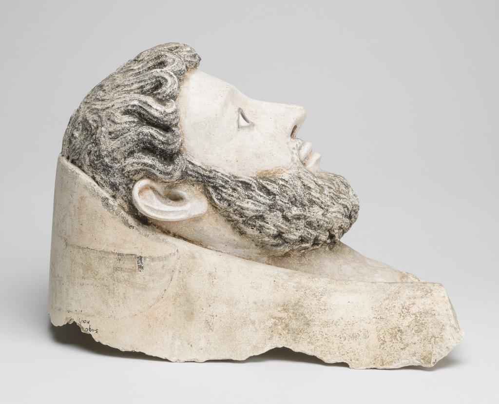 An image of Funerary equipment/Coffin. Face mask, male bearded, inlaid eyes, with part of mummy case attached. Height 34 cm, circa 150. Roman Period. Find Spot: Egypt.