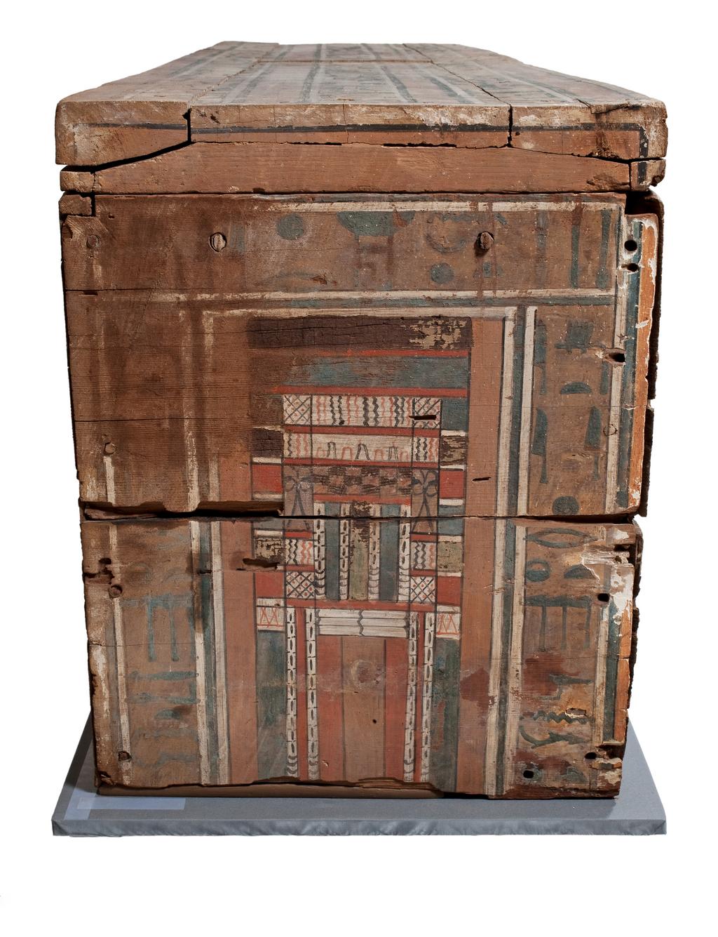An image of Funerary Equipment. Coffin, with lid. Inscribed for a woman with the title 'Lady of the House' called Nakht. Production Place: Egypt. Find Spot: Beni Hasan; tomb 23. Wood, painted, height 0.545, m, length 1.855, m, width 0.438, m, 1985-1773 B.C. Twelfth Dynasty. Middle Kingdom.