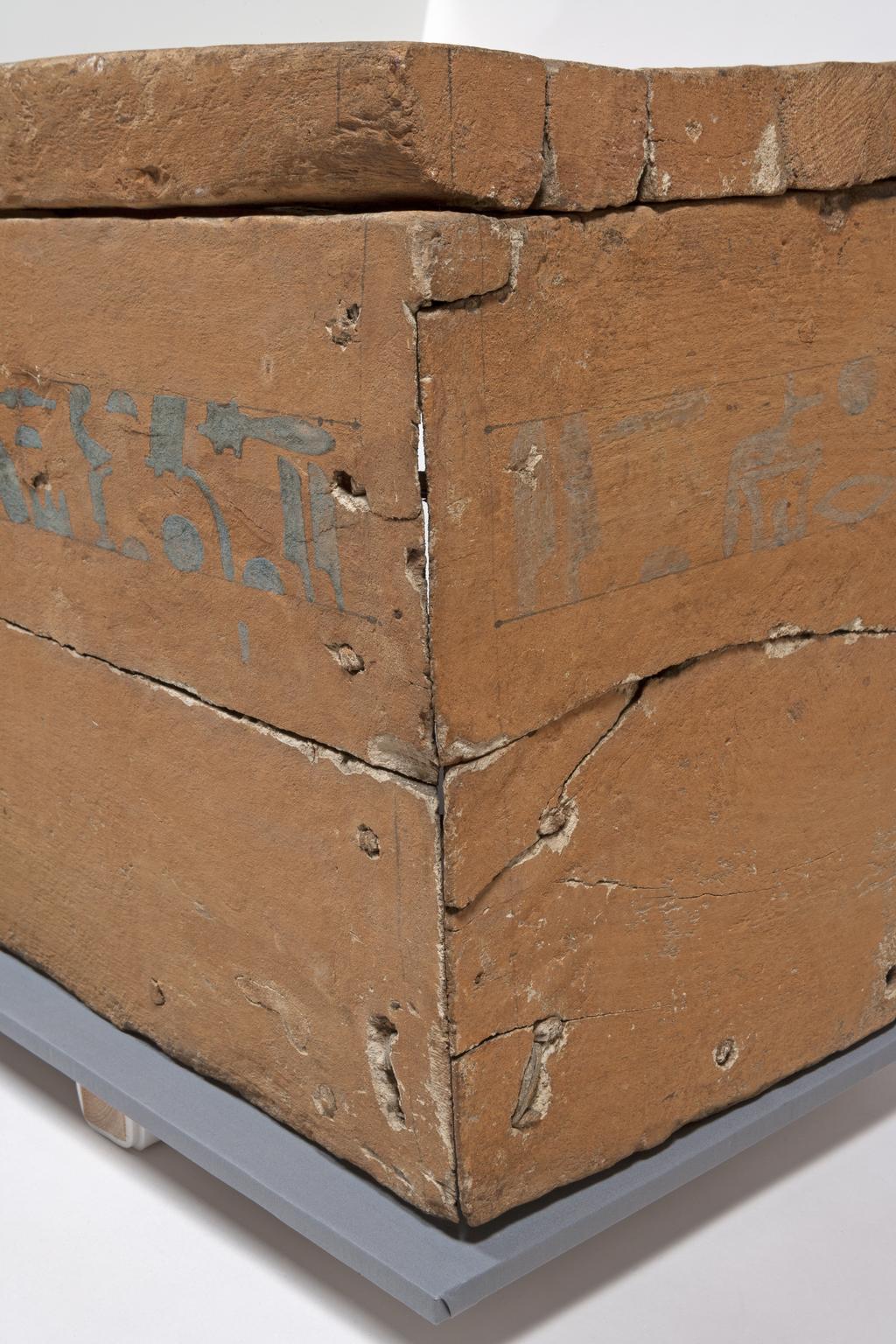 An image of Funerary Equipment. Coffin of Khety made of sycamore fig; part of one side is missing and original 'feet' lost; one line of painted text on lid and side; plastered wood painted with earth pigment. Black drafting lines still visible. Text sketched in back and coloured with Egyptian blue. An eye panel is painted on one side. Production Place: Egypt. Find Spot: Beni Hasan; 366. Wood, painted, height, 50, cm, length, 186, cm, width, 44.4, cm, ca 1990-1950 BC. Twelfth Dynasty; Middle Kingdom.