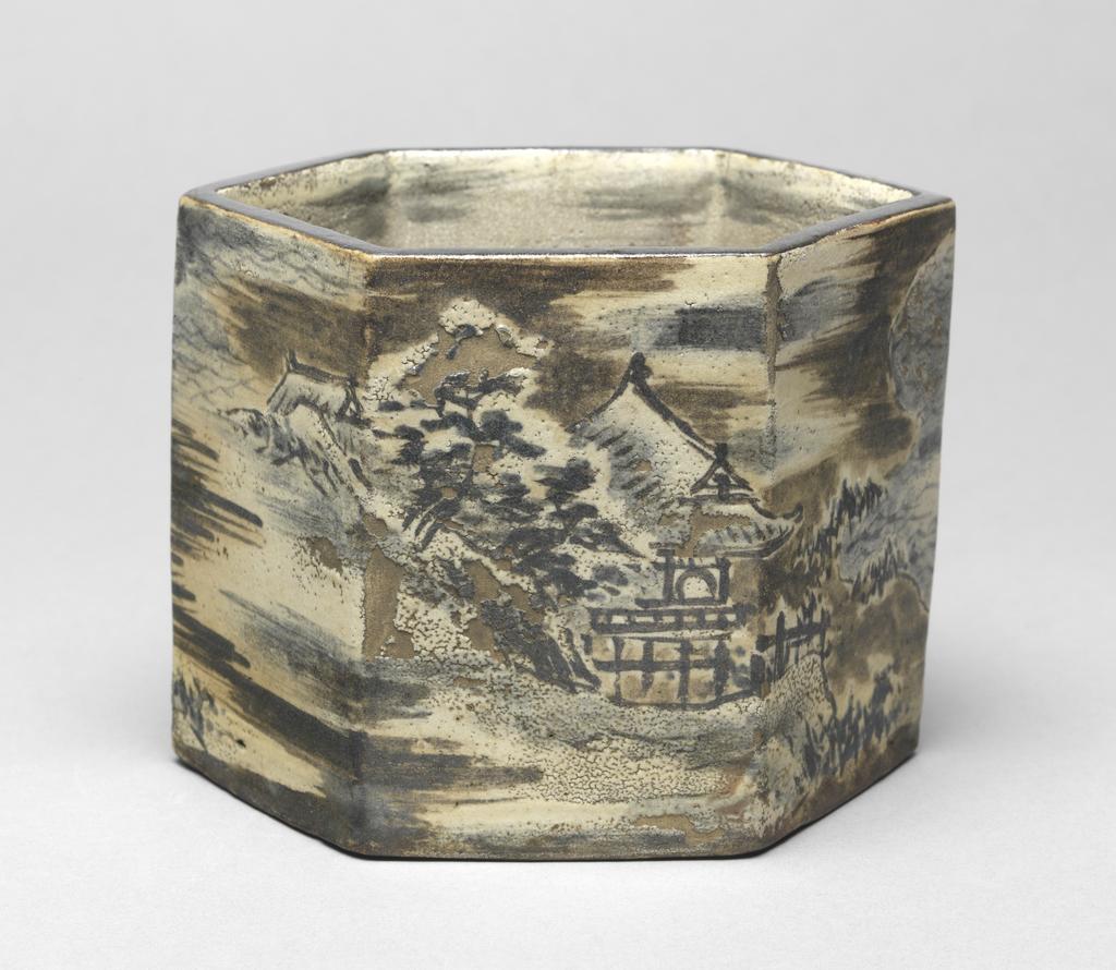 An image of Japanese pottery. Ember pot. Ogata, Kenzan (1663-1743). Ogata, Korin (1658 -1716). Production Place: Japan, Kyoto. Hexagonal brown stoneware pot, slab-built with lifted base. Winter landscape decoration continues round all six sides, comprising temple by a lake, house, gazebo, trees, clouds and waves, in subdued colours; cream, blue, brown, black. Black rim. Cloud decoration continues inside. Stoneware, hand-built, with brush painting pigments, height 10.90 cm, diameter, rim, 14.20 cm, diameter, base, 14.50 cm, 1658-1743. Edo Period (1615-1868). Production Note: the landscape is almost certainly by Korin.