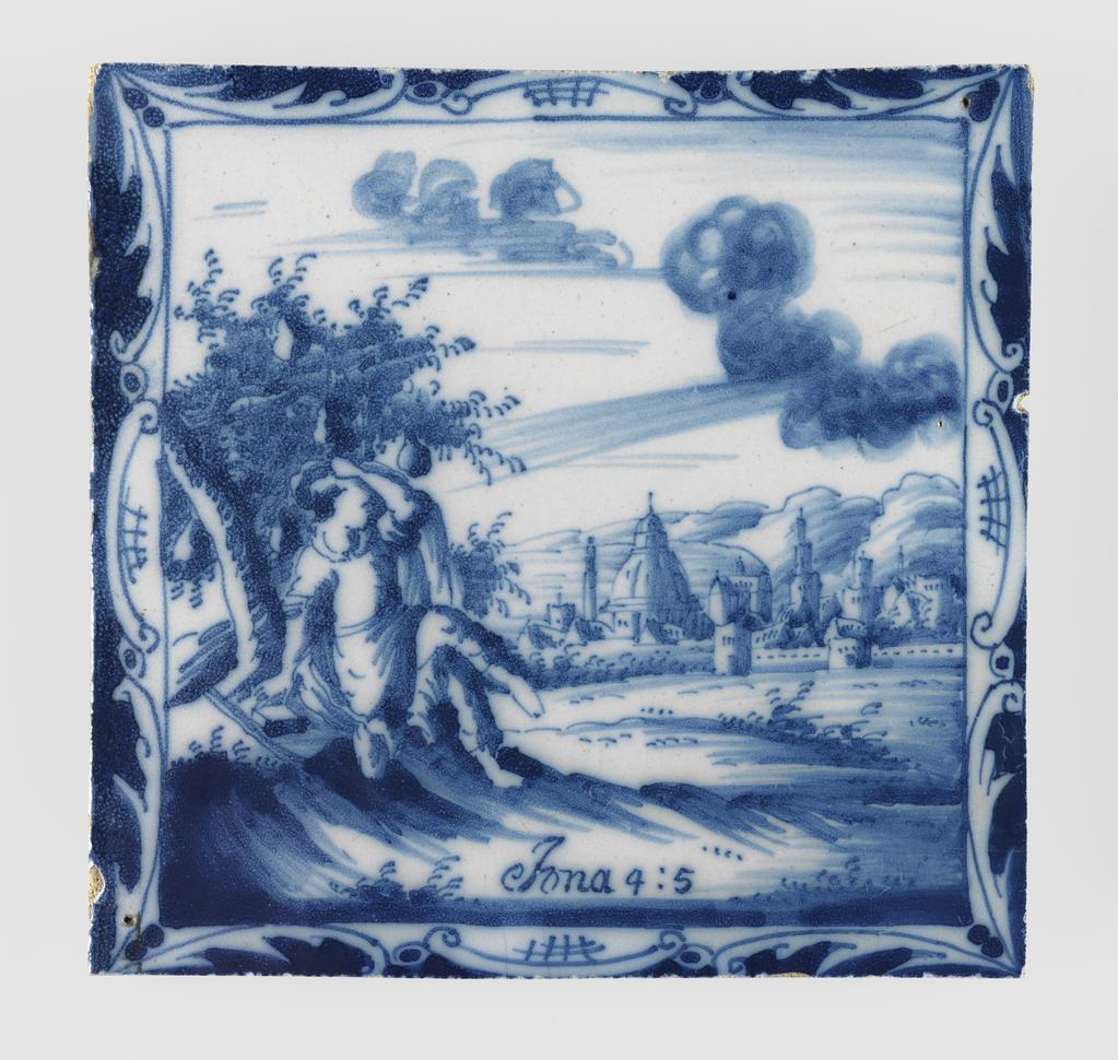 An image of Tile. Jonah under the Gourd. Production Place: The Netherlands.In a square, framed by a scrolled border, 'Jonah under the Gourd'. Inscribed below, 'Iona 4:5'. There is a hole in the top right and in the lower left corner. Earthenware, tin-glazed white on the upper surface and painted in blue, height, whole, 12.2 cm, width, whole, 12.7 cm, depth, whole, 0.8 cm, circa 1700-1800.
