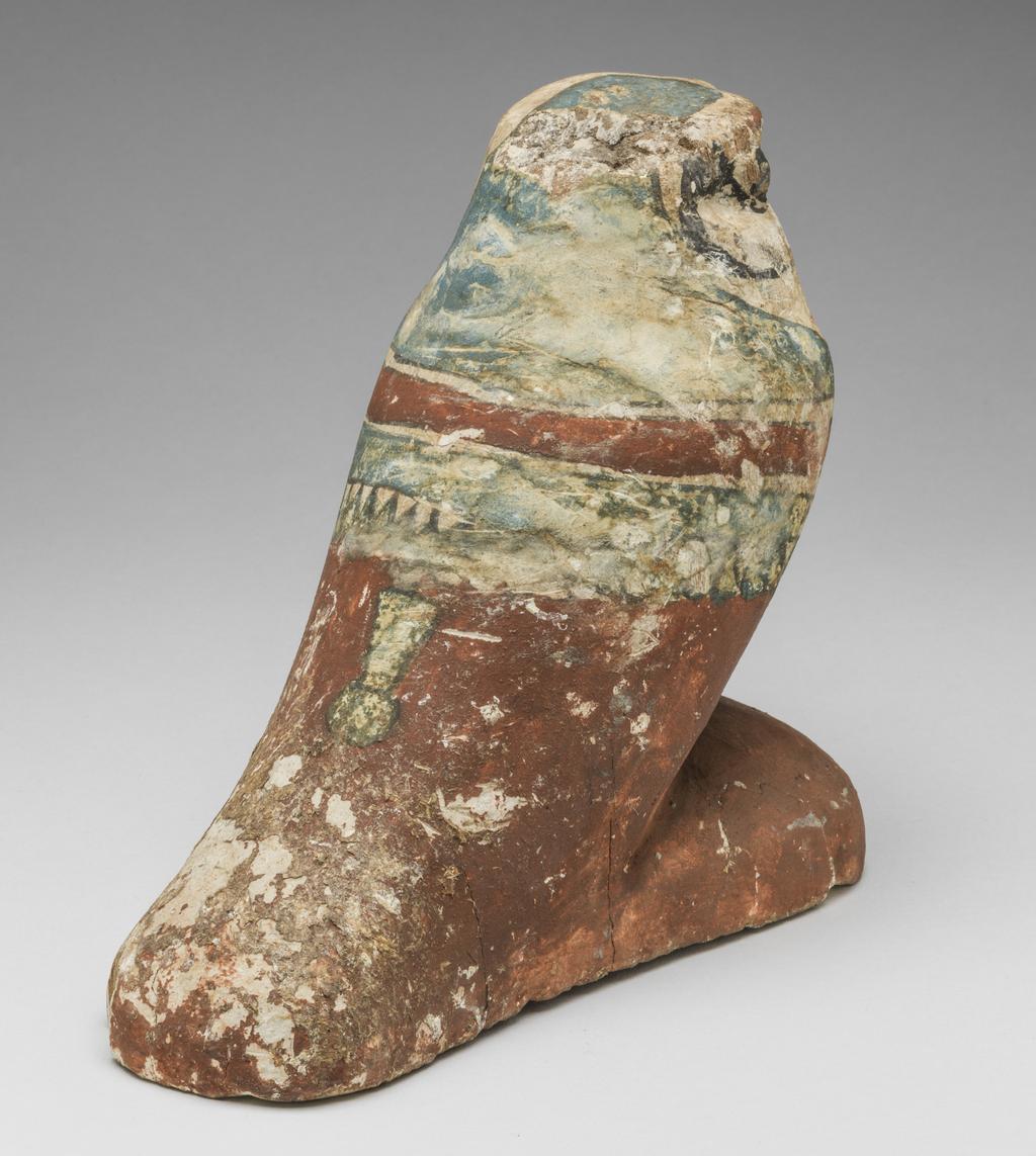An image of Funerary Equipment/Figurine. Mummified falcon figure. Production Place: Egypt. Wood, height 0.165 m.