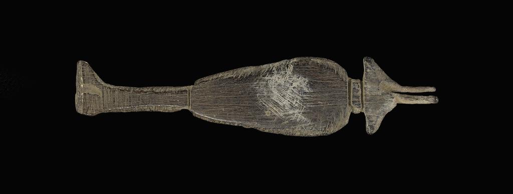 An image of Furniture element. Hes-vessel, furniture attachment. Production: Egypt. Wood, height 0.085 m, length 0.003 m, width 0.0185 m.