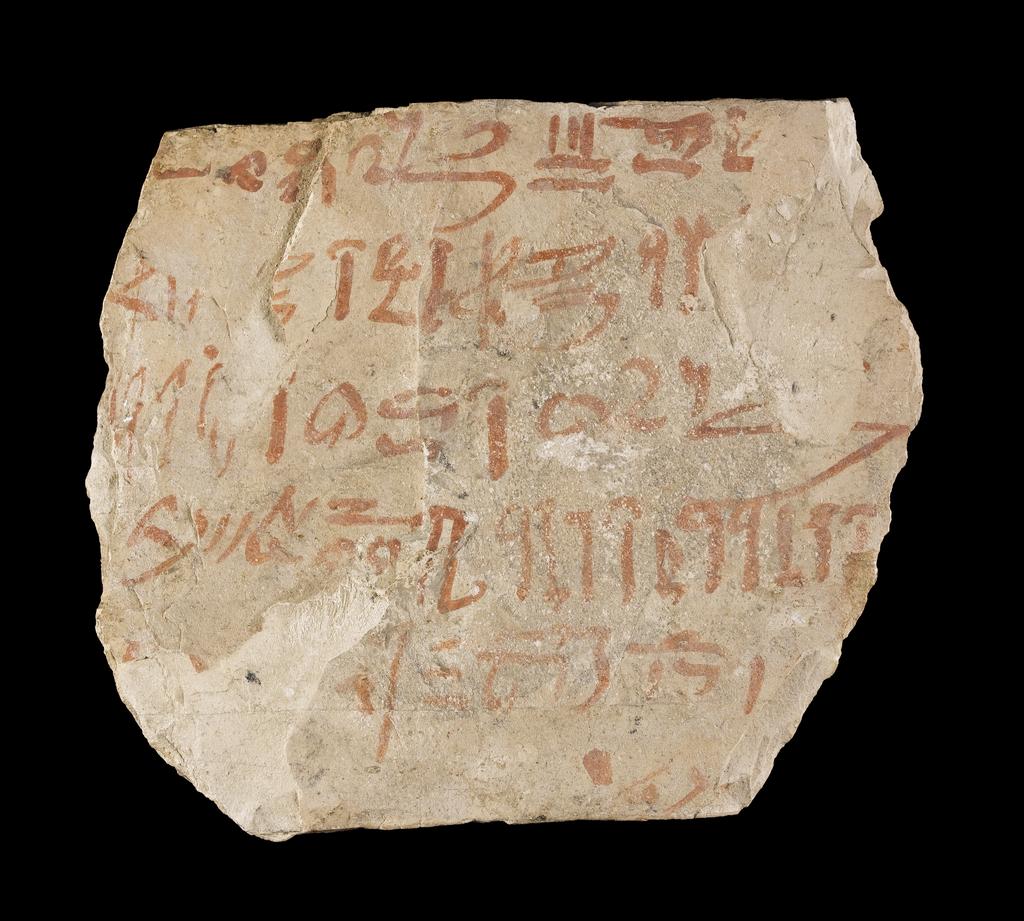 An image of Written Document. Ostracon, hieratic text, one side, red ink. Production Place/Find Spot: Egypt. Limestone, length 0.095 m, width 0.111 m. New Kingdom.