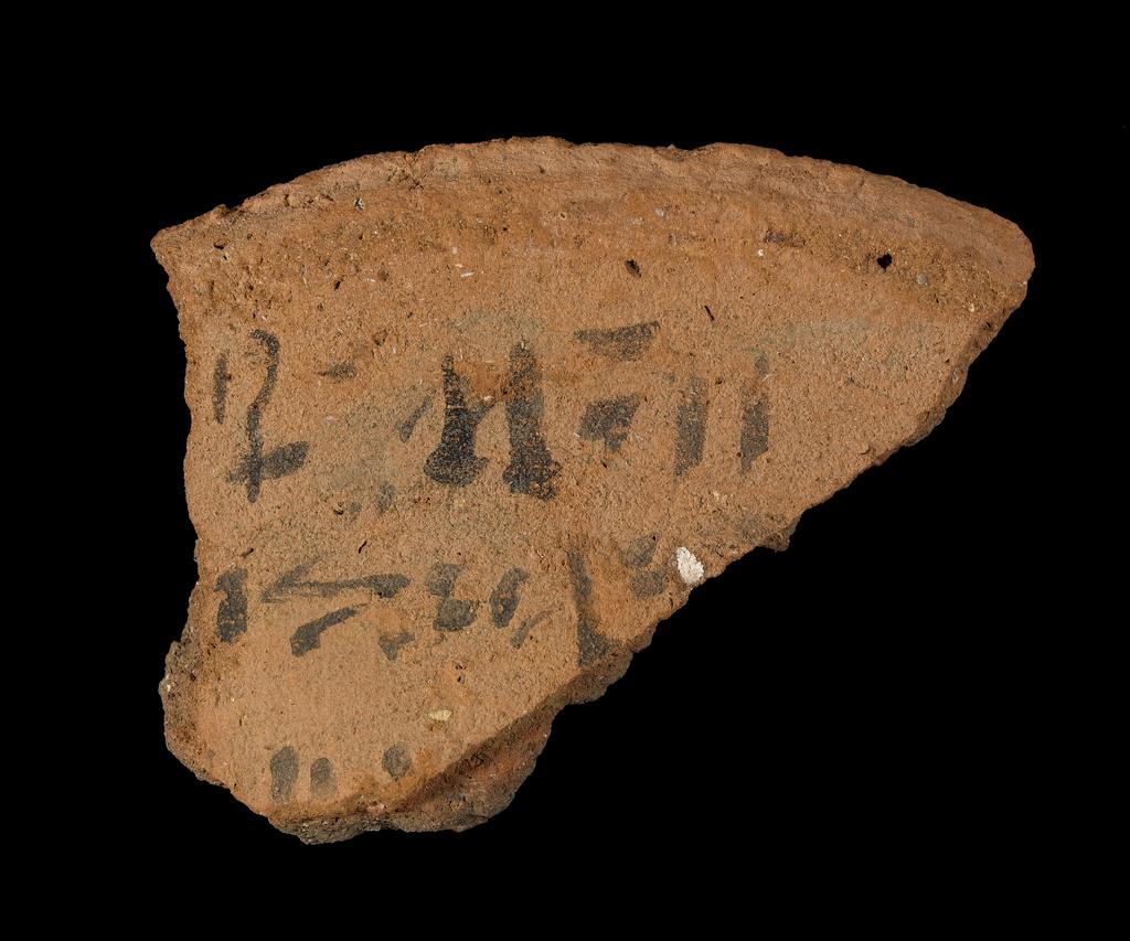 An image of Written Document. Ostracon, fragment of rim of bowl, inscribed in hieratic in black ink on both sides. Production Place/Find Spot: Egypt. Height 0.048 m, width 0.038 m. New Kingdom.
