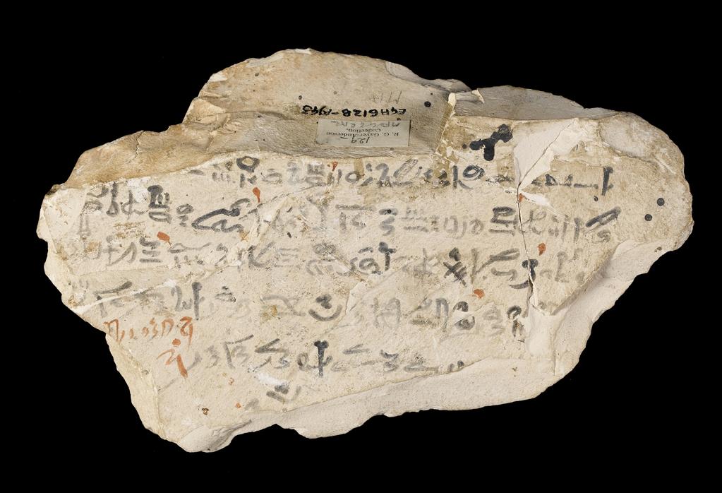An image of Written Document. Ostracon, hieratic text, both sides, black and red ink. Production Place/Find Spot: Egypt. Limestone, length 0.124 m, width 0.203 m. New Kingdom.