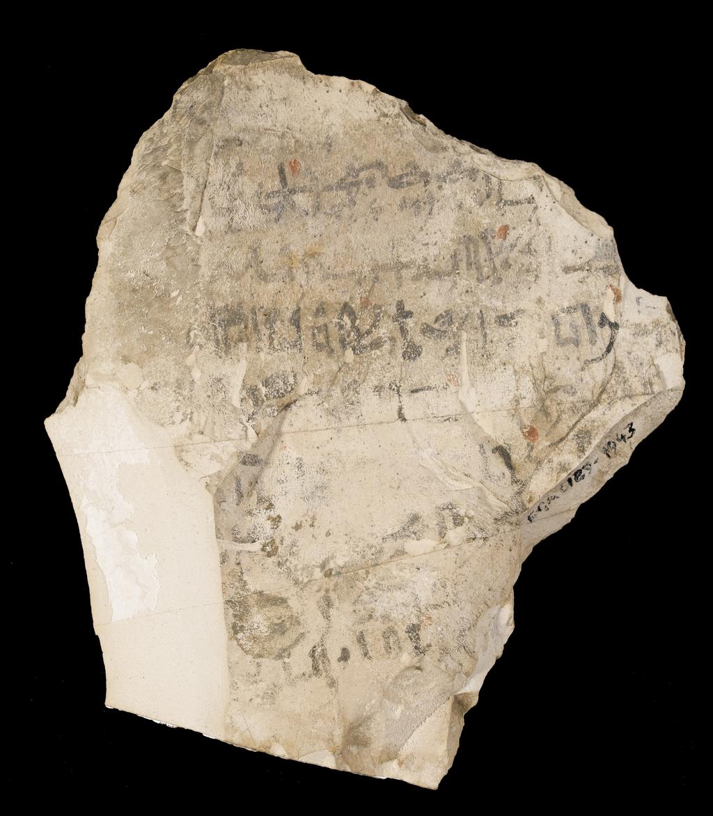 An image of Written Document. Ostracon, hieratic text, both sides, black and red ink. Production Place/Find Spot: Egypt. Limestone, length 0.161 m, width 0.143 m. New Kingdom.