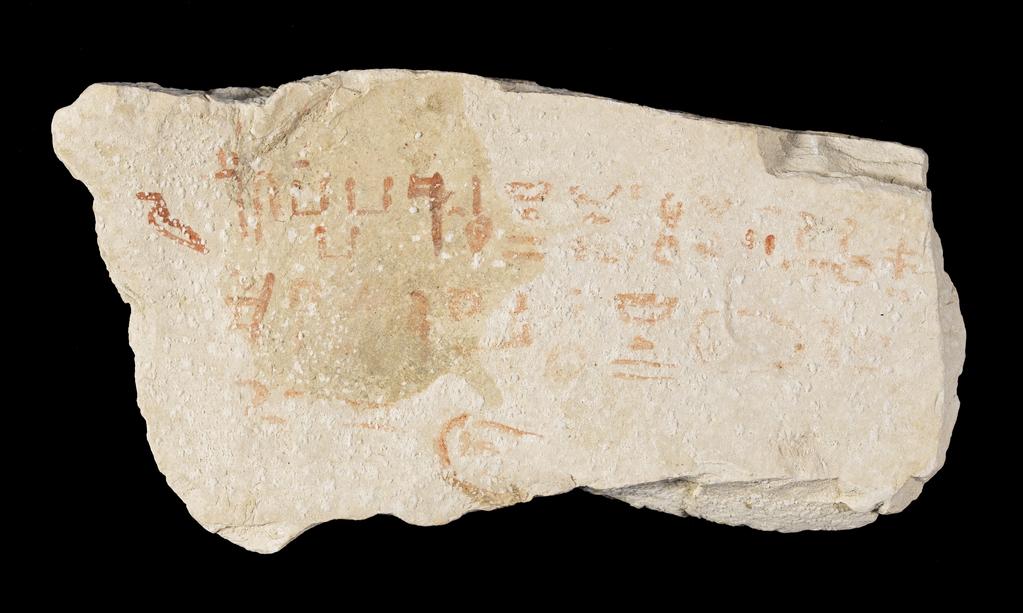 An image of Written Document. Ostracon, hieratic text, one side, red ink. Production Place/Find Spot: Egypt. Limestone, length 0.075 m, width 0.138 m. New Kingdom.