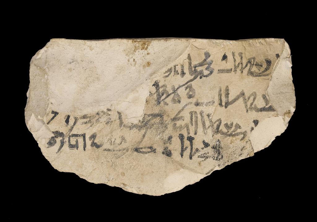 An image of Written Document. Ostracon, hieratic text, both sides, black ink. Production Place/Find Spot: Egypt. Limestone, length 0.123 m, width 0.072 m. New Kingdom.