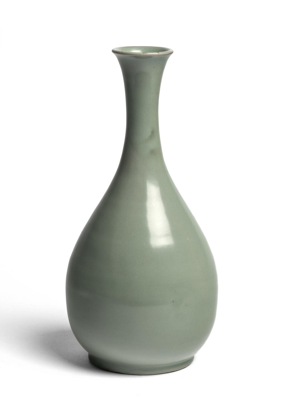 An image of Wine bottle. Unknown pottery, Korea, South Cholla province, Kangjin-gun, Sadang-ri kilns. This bottle has an elegant outline, with a long neck that flares towards the mouth, and a pear-shaped body. It is completely plain. The foot is wide but very low. The body is of fine clay; the clear semi-transparent glaze is evenly applied all over the body and subtly shimmers in a fine jade colour. The foot is completely glazed, and the base shows five quartzite spur-marks. Stoneware, thrown and celadon-glazed. Height, bottle, 29.6 cm, diameter, rim, 5.4 cm, diameter, foot, 9.8 cm, circa 1100-1150. Koryo Dynasty.