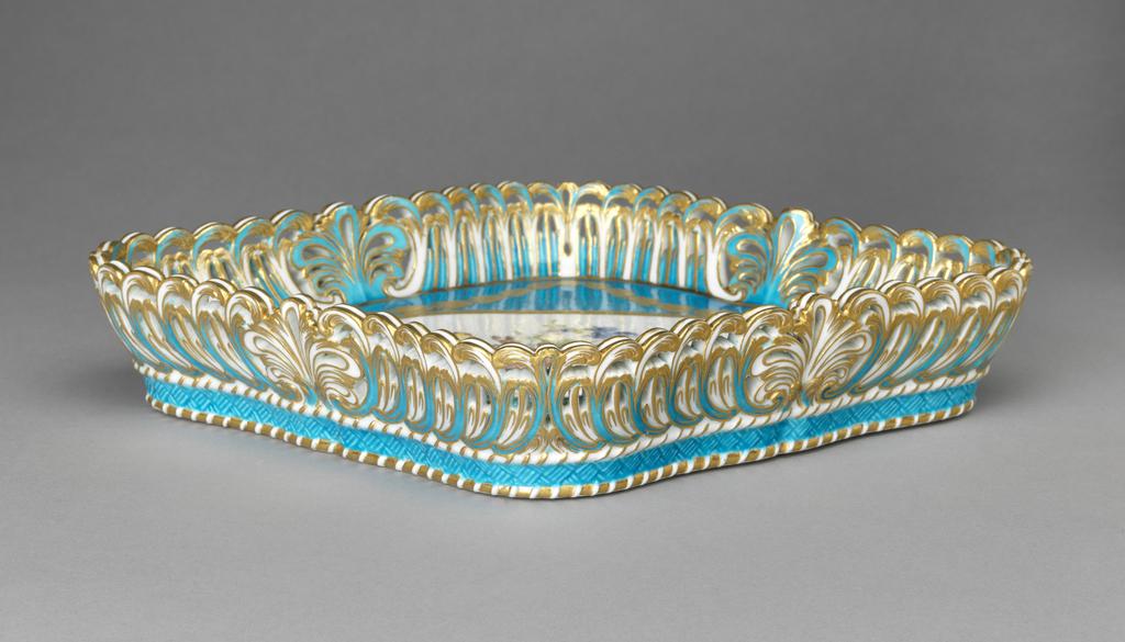 An image of Tray/Plateau losange corbeille à jour. Sèvres Porcelain Manufactory. Censier, Charles, répareur, possibly (French, op. 1758-1775). Soft-paste porcelain with pierced sides, decorated with a bleu céleste ground, a reserve painted in enamels with a bouquet of flowers, and gilding. height 5.5 cm, length 30.5 cm, width 25.5 cm, 1769. Rococo. Louis XV.