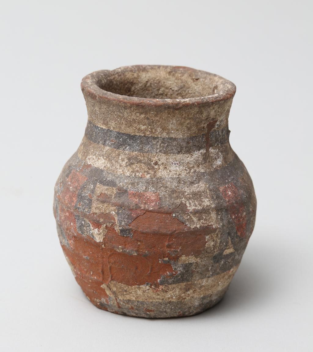 An image of Vessel. Jar, with decoration in black and red paint. Find Spot: Abydos?, Egypt. Production Place: Egypt. Height 0.065 m.