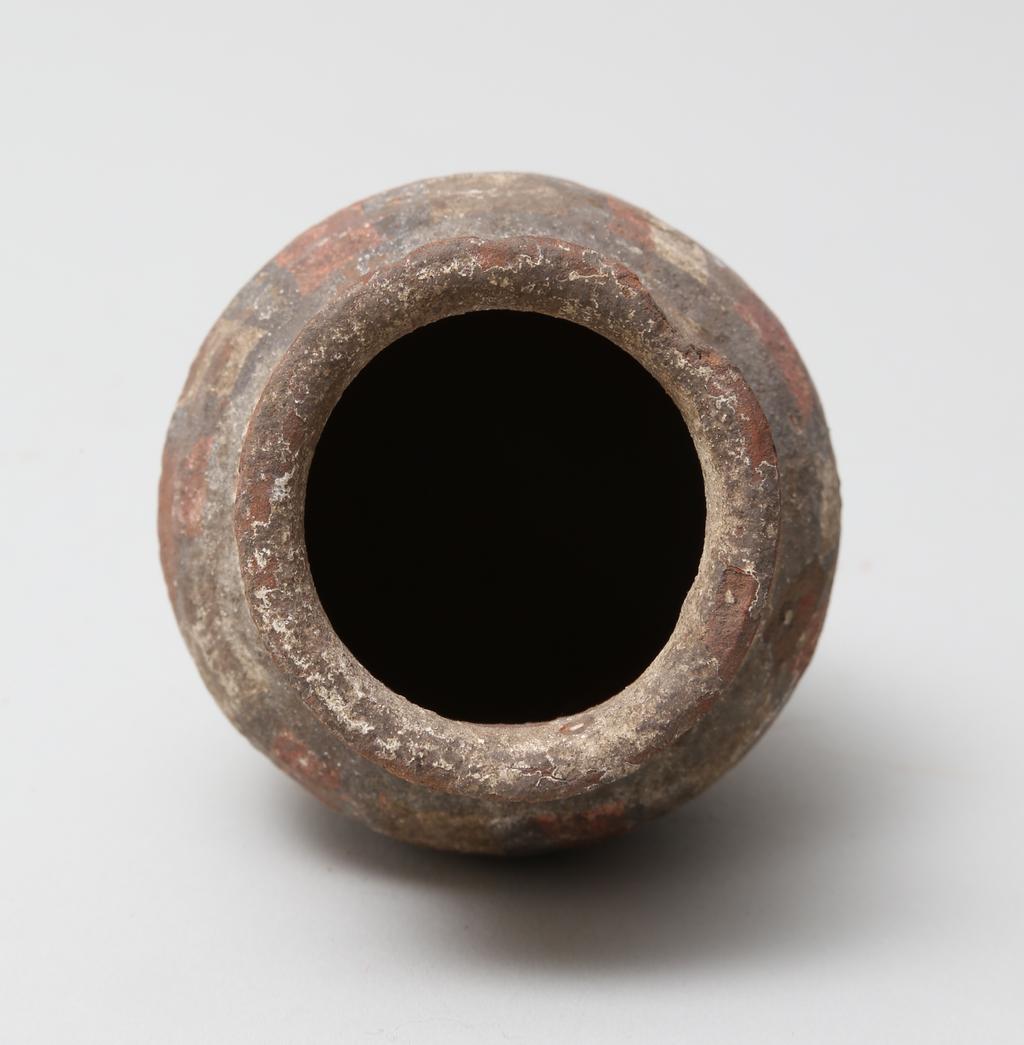 An image of Vessel. Jar, with decoration in black and red paint. Find Spot: Abydos?, Egypt. Production Place: Egypt. Height 0.065 m.