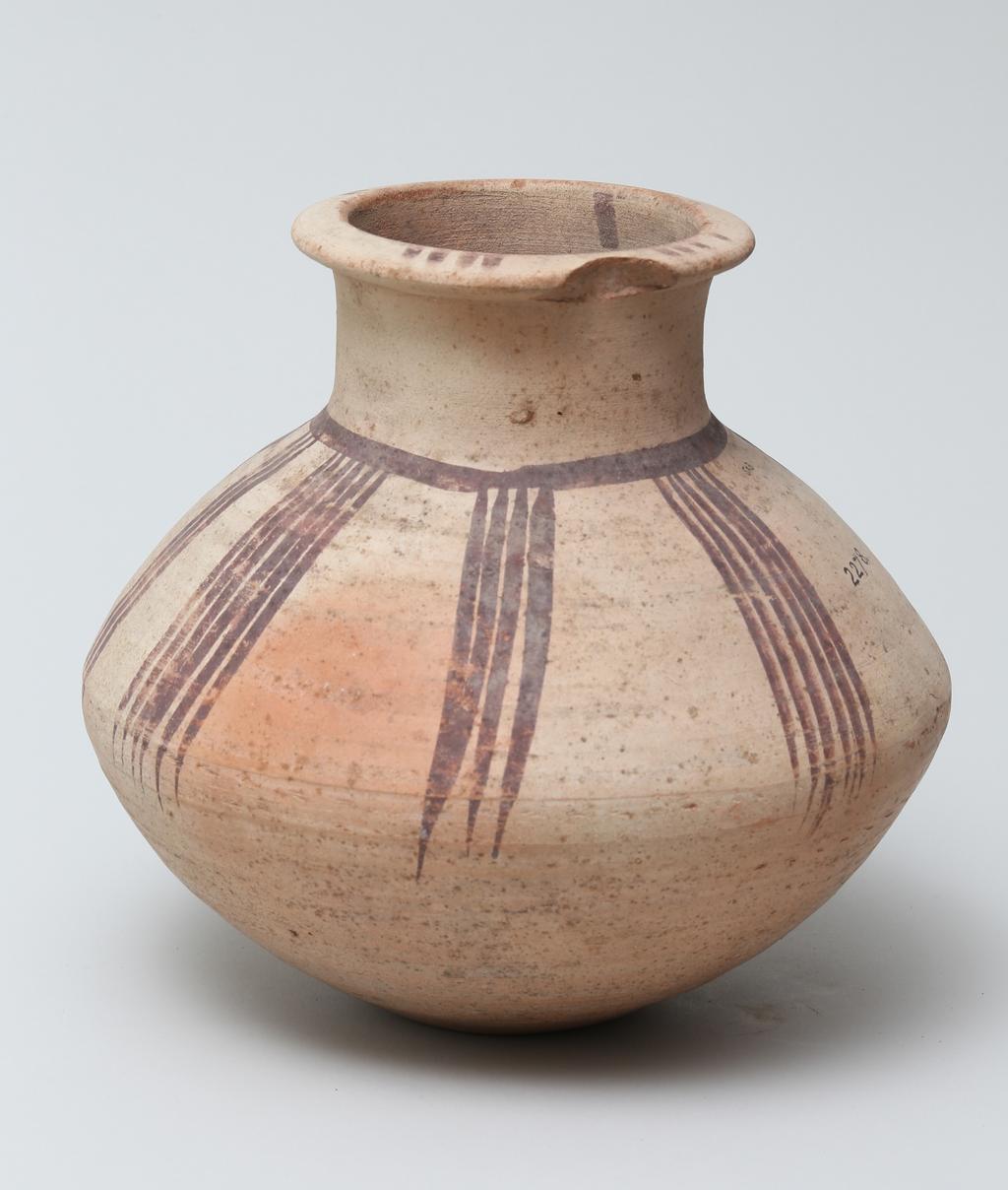 An image of Vessel. Jar, carinated, with line decoration in brown. Production Place/Find Spot: Egypt. Height 0.195 m. Eighteenth Dynasty. New Kingdom.