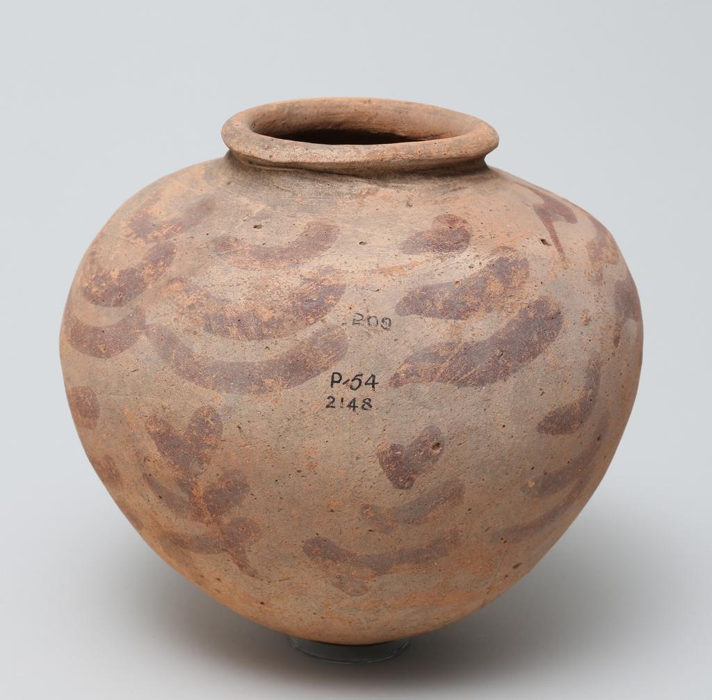 An image of Vessel. Jar, broad shouldered, globular form, with comma shaped decoration in red paint. Production Place: Egypt. Find Spot: Ballas, Egypt. Height, 0.155, m. Predynastic period.