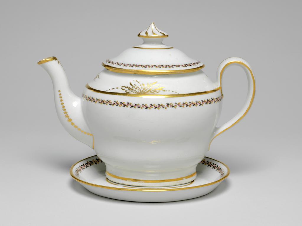 An image of Teapot and stand. New Hall Porcelain Factory, Staffordshire. The teapot and cover (A) are of oval ogee form. The stand (B) is oval with sloping sides and flat base. There are ten holes forming an ellipse surrounding one hole behind the spout, one ventilation hole in the cover, and anothe under the knob. The exterior of the pot is decorated below the shoulder by border comprising a wavy black stem with tiny trefoil leaves, puce berries, and gold trefoil leaves. Above the shoulder there is an an arrangment of gold foliage on each side of the pot and a gold sprig at each end. Gold bands run found the footring, the shoulder, the rim, the sides of the handle, and the tip of the spout. There is a vertical gold line down the back of the handle. Each side of the spout is decorated with a row of gold stars over a line which runs on round its junction with the body. Below the lip there is a gold wavy dotted line over a vertical row of narrow leaves altenating with spots. The cover is decorated en suite, and has eight swirling gold lines radiating from the top of the knob. The stand has a central stylized star-like flower surrounded by an oval gold band, a matching border, and a gold band on the edge. Pattern no. 280. Hybrid hard-paste porcelain, moulded, glazed, painted overglaze with black and puce enamel, and gilded. Height, teapot, 17.5 cm, length, teapot, 24.2 cm, height, stand, 2 cm, length, stand, 17.7 cm, width, stand, 14.6 cm, circa 1797-1803.